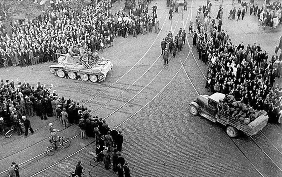 A Soviet BT Tank with a truck and troops in the center of Riga, 1940.